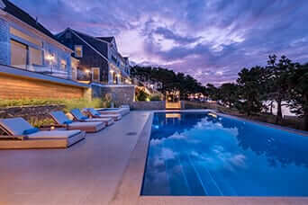Illuminated infinity-edge pool at dusk