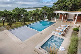 Rectangular gunite pool and spa overlooking the water